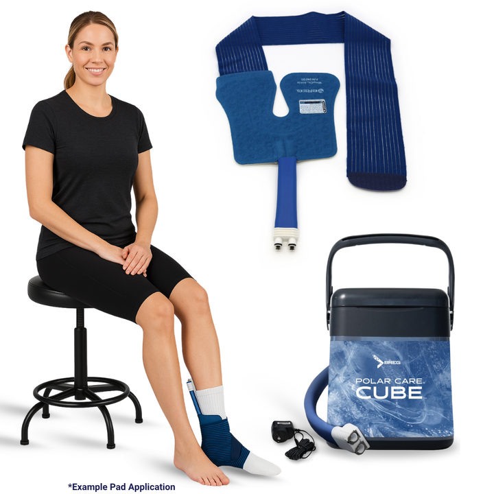 Woman using Breg Polar Care Cube cold therapy machine with ankle pad on foot