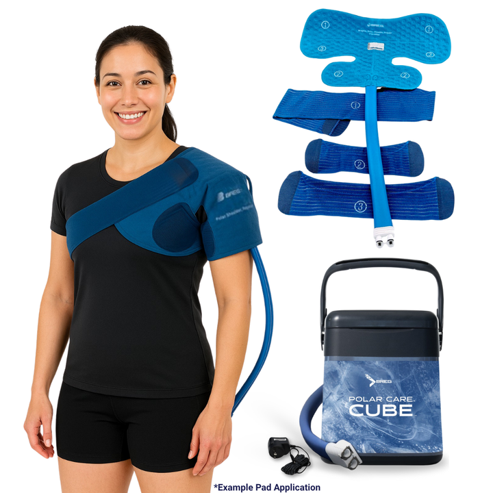 Woman wearing Breg Polar Care Cube shoulder cold therapy system with pad, straps, and cooler